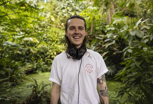 Todd smiling in Rainforest Biome with headphones